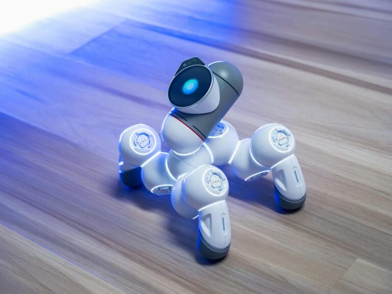 Close-up of a modern robotic toy with glowing features on a wooden floor, showcasing innovative technology.